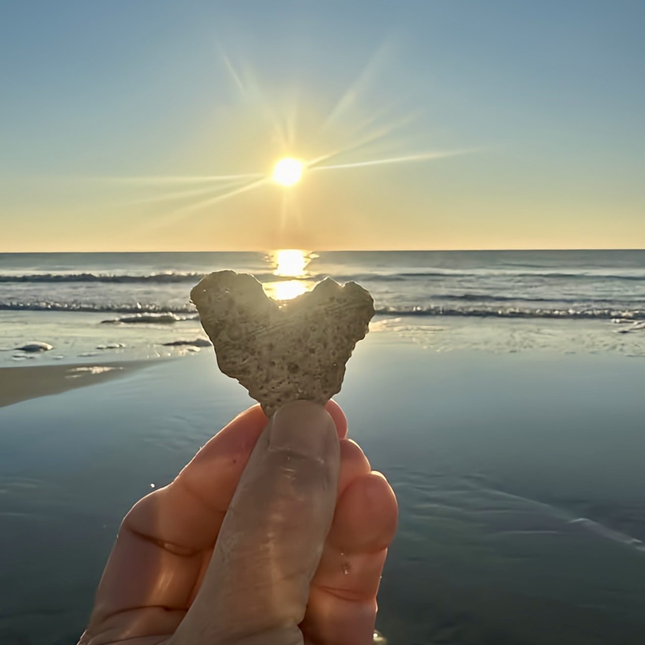 Reset and Renewal Clarity Image of two people holding a heart at sunset